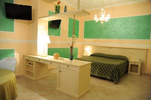 a living room with a bed and a table and a couch at Hotel Villa Santa Maria in Villapiana