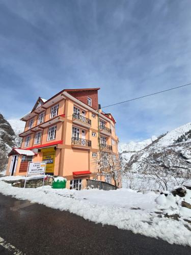 a building on the side of a snow covered mountain at Hotel Lady of Keylong in Kyelang