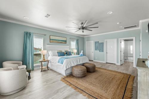 a bedroom with a bed and a ceiling fan at The Elevated Spoonbill Dog-Friendly Beach Retreat in Bolivar Peninsula