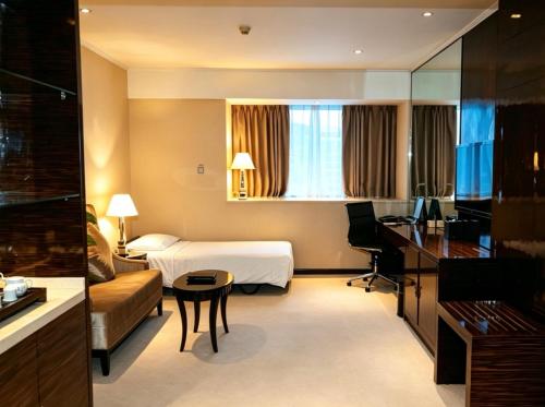 a hotel room with a bed and a desk at Dorsett Chengdu in Chengdu