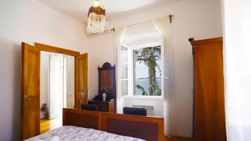 a bedroom with a bed and a window at Villa Agnes in Orebić