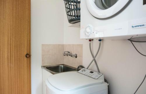 a small bathroom with a toilet and a sink at Whalers Cottage in Port Fairy