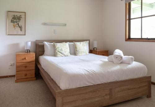 a bedroom with a bed with a towel on it at Whalers Cottage in Port Fairy