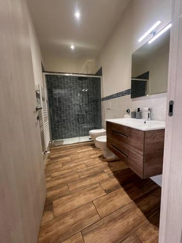 a bathroom with a sink and a toilet and a shower at La terrazza di Isma in Ghizzano