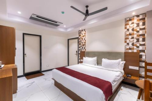a bedroom with a large bed in a room at Lumis Beach Hotel in Visakhapatnam