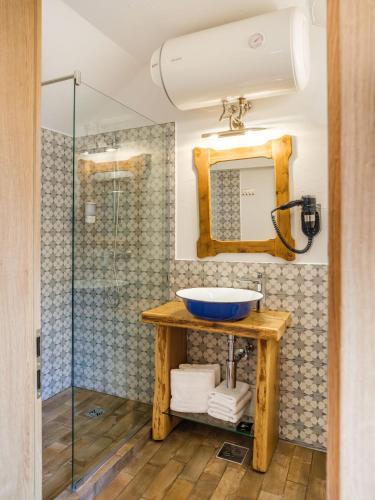 a bathroom with a sink and a glass shower at ISSA Village in Turda