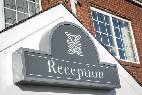 a sign for a restaurant on the side of a building at Celtic International Hotel Cardiff Airport in Barry