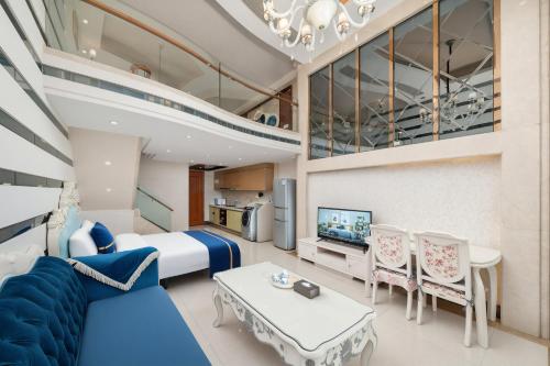 a room on a cruise ship with a bed and a tv at Louidon Mega Duplex Apartment - Beijing Rd in Guangzhou