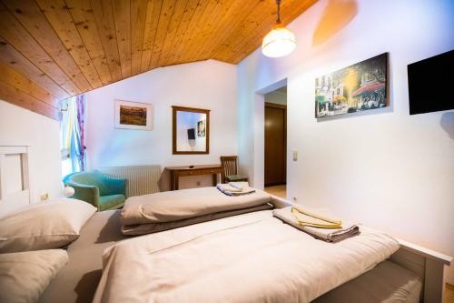 a room with two beds and a tv in it at Naturgut Gailtal in Sankt Stefan an der Gail