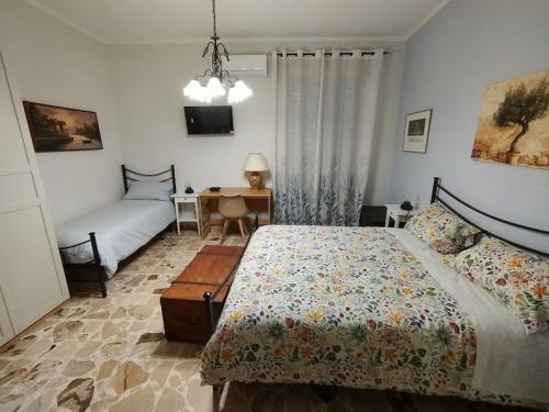 a bedroom with a bed and a desk in it at Orto dei Frati in Sortino