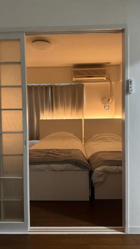 a bedroom with two bunk beds in a room at OLIVE Stay in Fukuoka