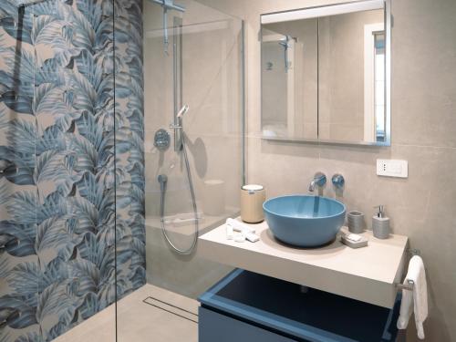 a bathroom with a sink and a shower at Anfiteatro - Spacious and elegant residence in Lucca