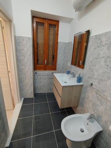 a bathroom with a sink and a toilet at Orto dei Frati in Sortino