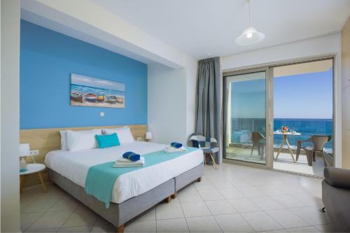 a bedroom with a bed and a view of the ocean at SEPERI Deep Blue in Rethymno