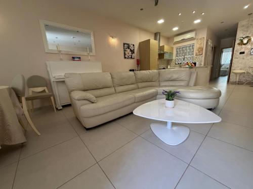 a living room with a couch and a table at S'Agapo Maisonette St' Julians in St. Julianʼs