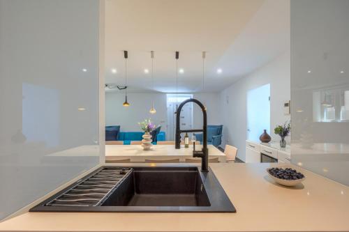 a kitchen with a sink and a counter top at Villa Majestic with heated pool and rooftop terrace in Bol