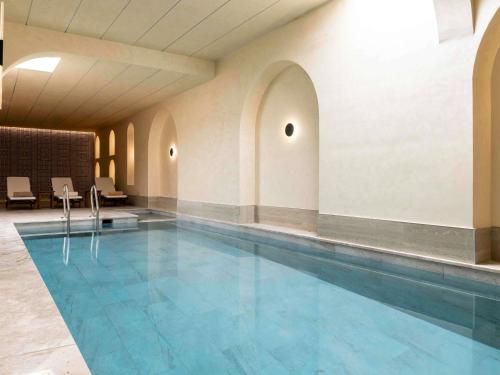 a large swimming pool in a building at Mövenpick Istanbul Old Town in Istanbul