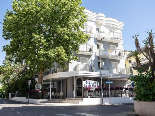 a white building with a sign in front of it at Residence Mareo in Riccione