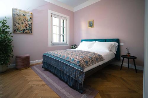 a bedroom with a bed and a window at Anfiteatro - Spacious and elegant residence in Lucca