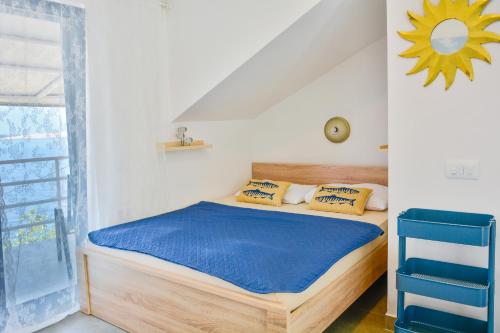 a bedroom with a bed with a blue chair at Apartments Miki in Donja Klada