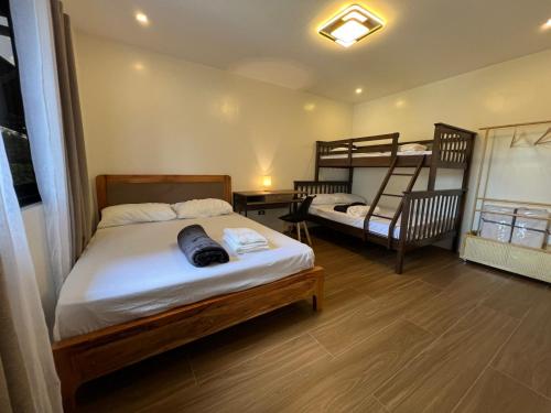two beds in a room with two bunk beds at Casa De Una Tagaytay in Galicias