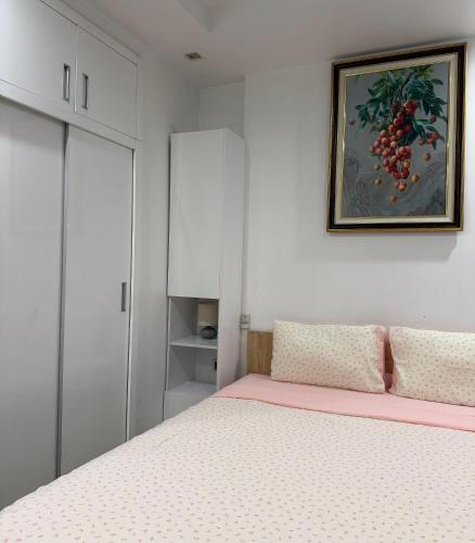a bedroom with a bed and a picture on the wall at QM House 08 in Hanoi