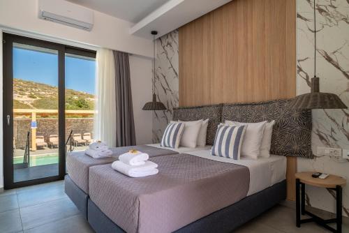 a bedroom with a bed with towels on it at Prasonisi Lighthouse Studios in Prasonisi
