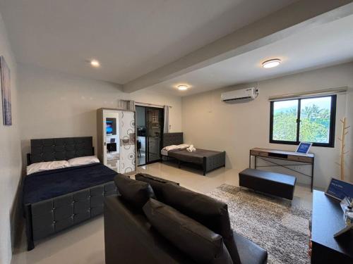 a living room with a bed and a couch at Stay at Diez in Calamba