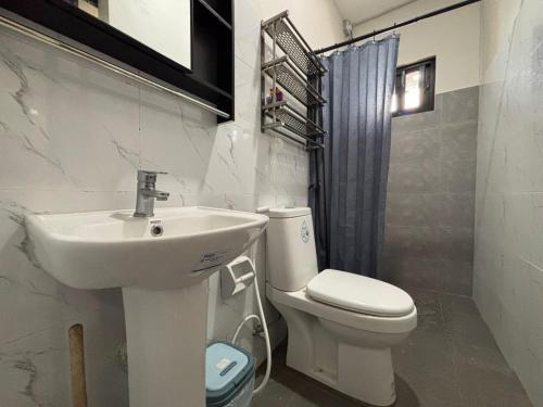 a bathroom with a sink and a toilet at Stay at Diez in Calamba