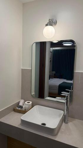 a bathroom with a sink and a mirror at Island Garden Beach Resort in Samal
