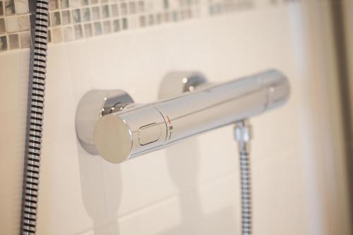 a metal towel bar on a white wall in a bathroom at Western Gate, Executive Central Apartments in Basingstoke