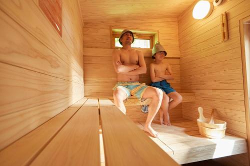 two young men sitting in a sauna at TinyCabinTATEGU#01 - Vacation STAY 04108v in Miyota