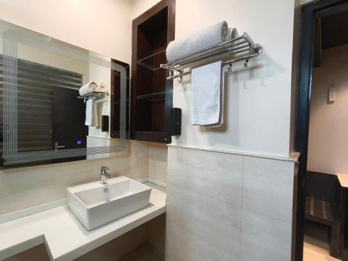 a bathroom with a sink and a mirror at Hotel Galaxy international Delhi igi Airport Free pickup in Ghaziabad