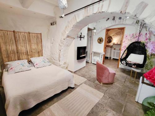 a bedroom with a bed in a room with an arch at La Bombonière & Spa in Roquebrune-Cap-Martin