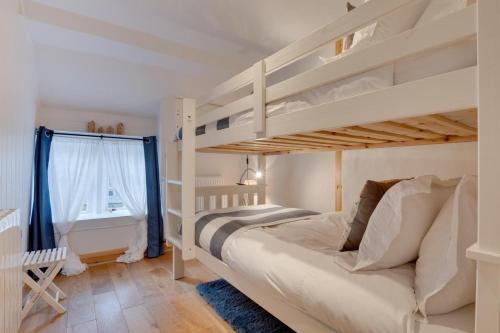 a bedroom with two bunk beds and a bathroom at 2 Bed in Scarborough oc-sa003 in Ravenscar