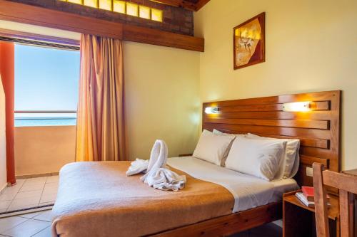 a hotel room with a bed with towels on it at Kato Stalos Mare in Stalos