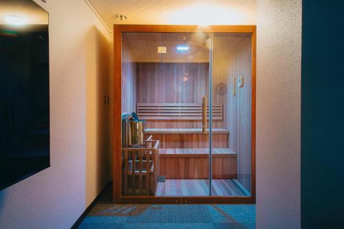 a room with a glass door to a room with stairs at Hamamatsu Station Hotel in Hamamatsu