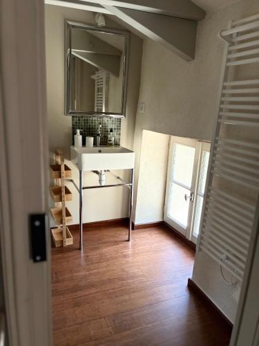 a bathroom with a sink and a mirror at LA CROIX DES GRANGES in Chapdeuil