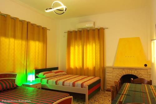 a bedroom with two beds and a fireplace at Garden house escape in Amarynthos