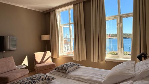 a hotel room with a bed and a window at Risør Hotel in Risør