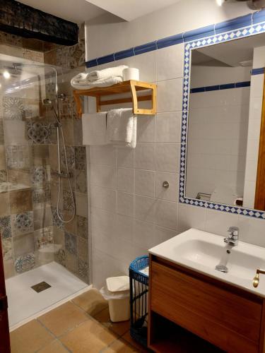 a bathroom with a sink and a shower and a toilet at Posada Campo in Suances