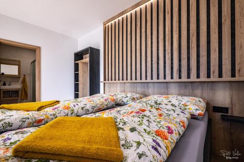 a bedroom with two beds with floral sheets at San Marco - Na Brněnské ulici in Mutěnice