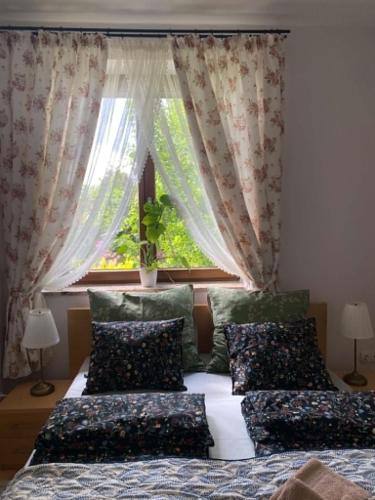 a bedroom with two beds in front of a window at Cozy Garden Apartment Near Krakow - Free Parking in Gaj