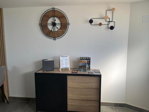 a desk in a room with a clock on the wall at Les champs étoilé in Morschwiller