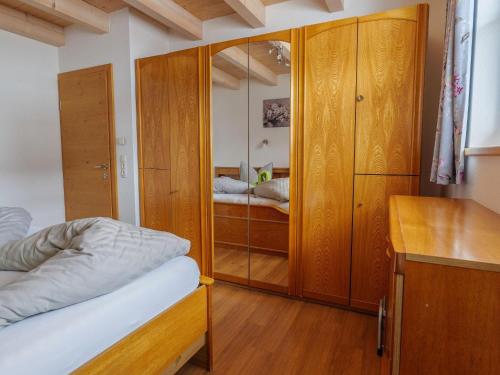 a bedroom with a bed and a wooden cabinet at Chalet near Passthurn Ski Area Kitzbühel in Mittersill