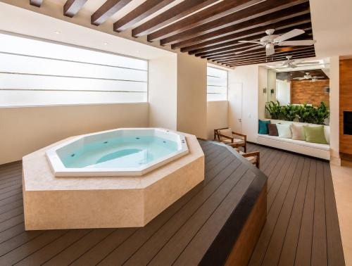 a jacuzzi tub in the middle of a room at Luxury Beachfront Condo at Del Canto Residences - Amazing Views! in Nuevo Vallarta