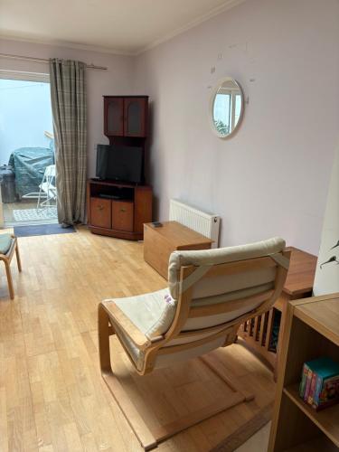 a living room with a chair and a table at Town Centre House in Clonakilty