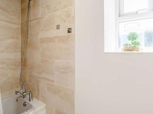 a bathroom with a shower and a window at 2 Bed in Lydbrook oc-83665 in Lydbrook