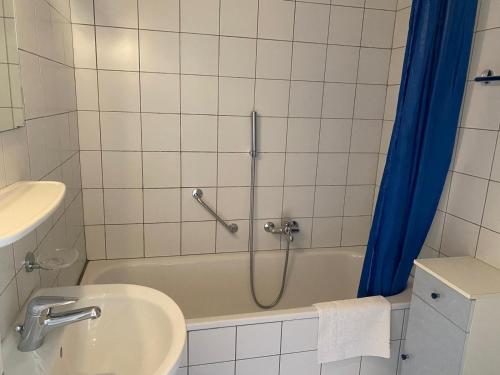 a bathroom with a tub and a sink and a shower at My Home Location in La Chaux-de-Fonds