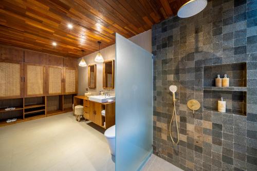 a bathroom with a toilet and a sink at Nayandra Uluwatu in Uluwatu